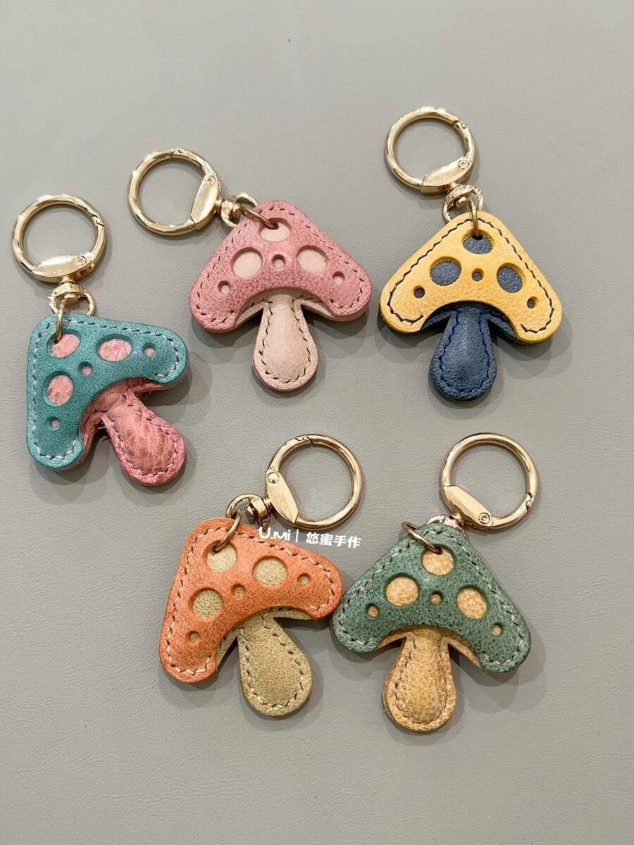 Handmade leather mushroom keychain charms, five colourways