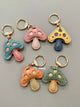 Handmade leather mushroom keychain charms, five colourways