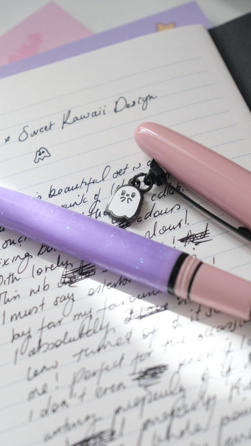 Pastel Halloween Estie resting on a handwritten page