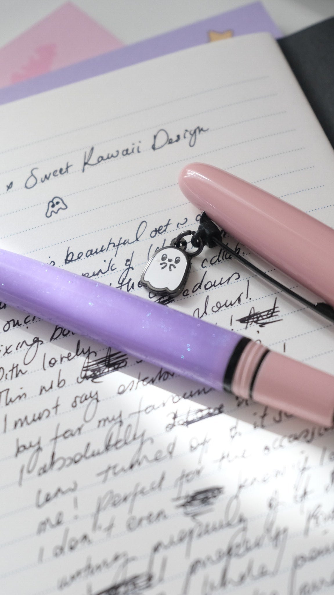 Pastel Halloween Estie resting on a handwritten page